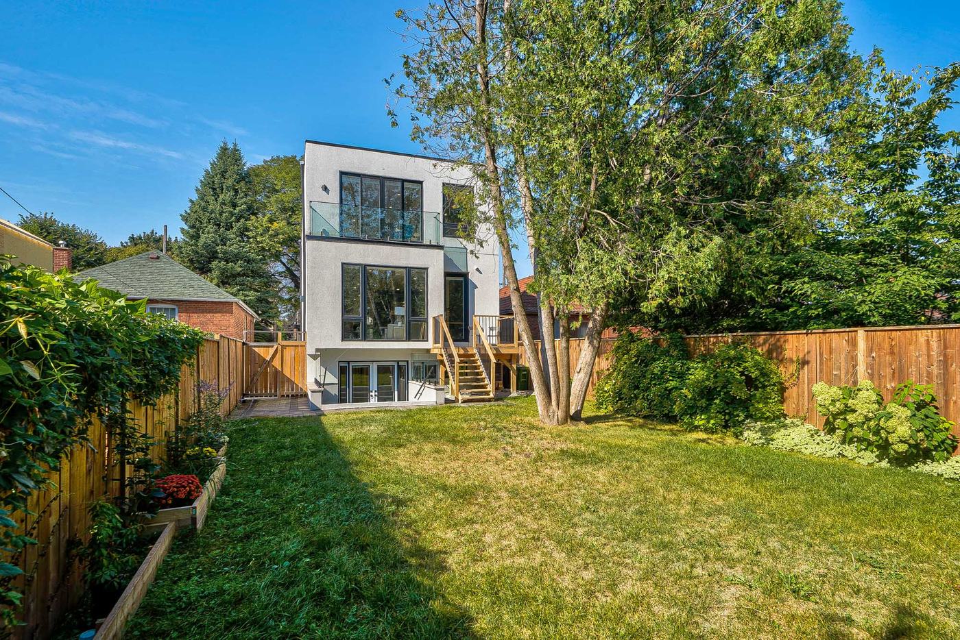 Rear facade and landscaped backyard — the building envelope's outdoor face