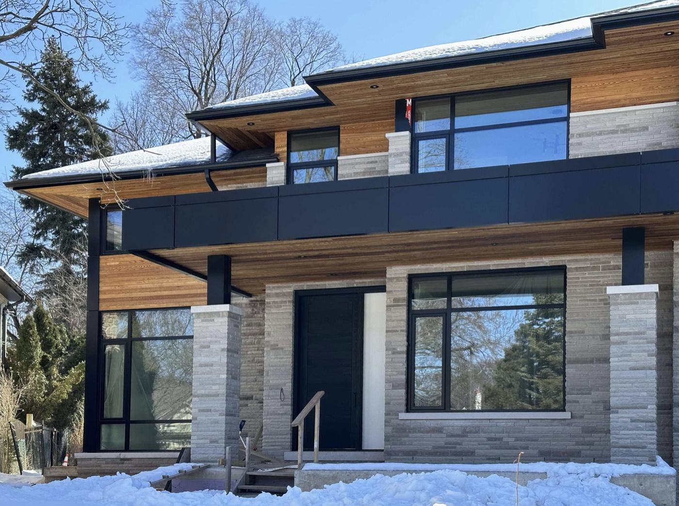 Modern two-storey custom home in winter — Berm Inc. project photo