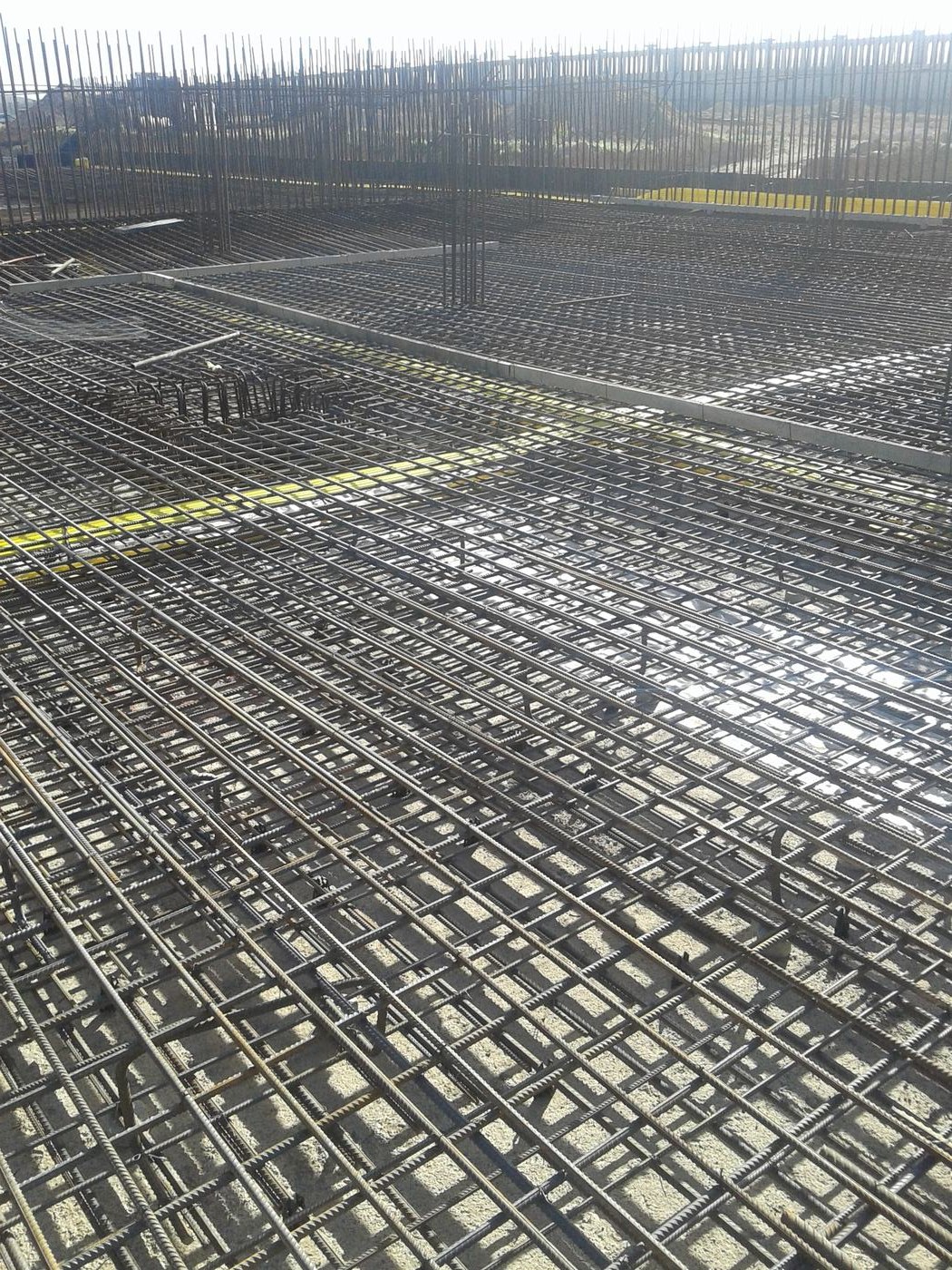 Rebar reinforcement grid installation on a Berm Inc. construction site