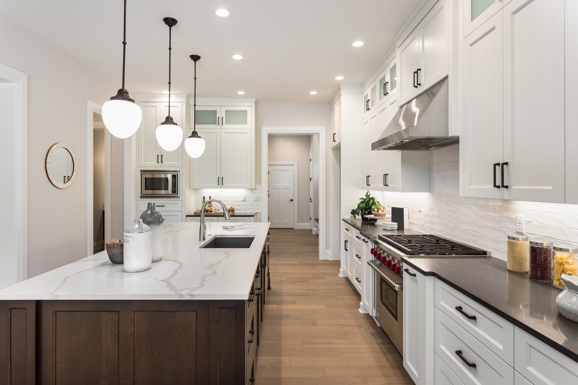 Premium kitchen with central island in a custom home built by Berm Inc.