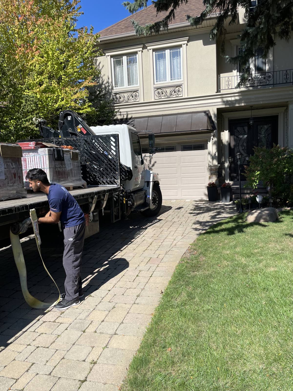 Wrapped stone and masonry materials secured on a delivery truck at a Berm Inc. project