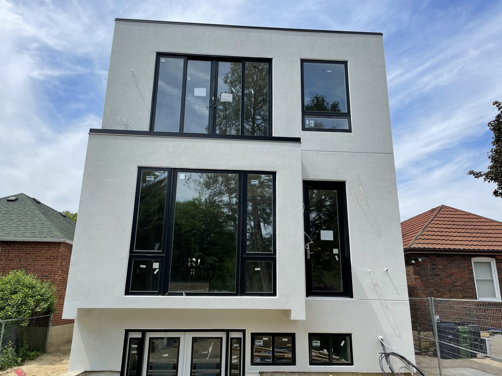 Rear elevation with black-framed glazing at exterior completion — Berm Inc. project photo