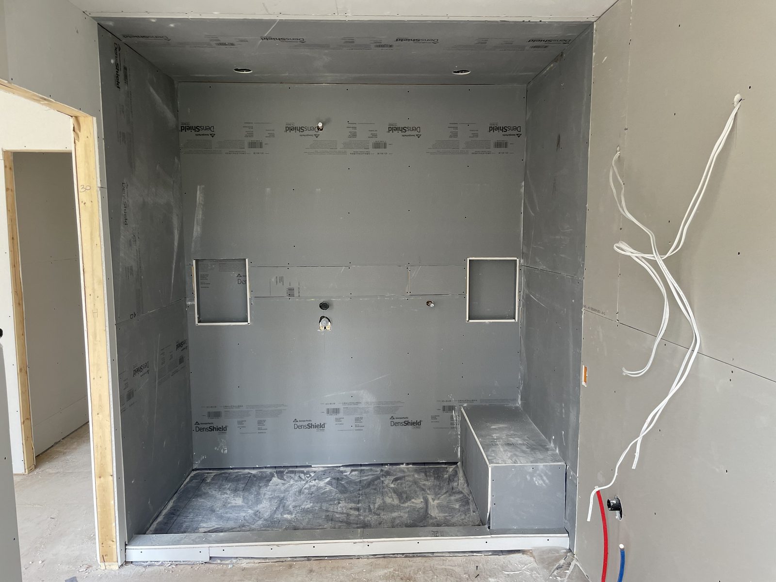 Walk-in shower rough-in with backer board, bench and niches — Berm Inc. project photo